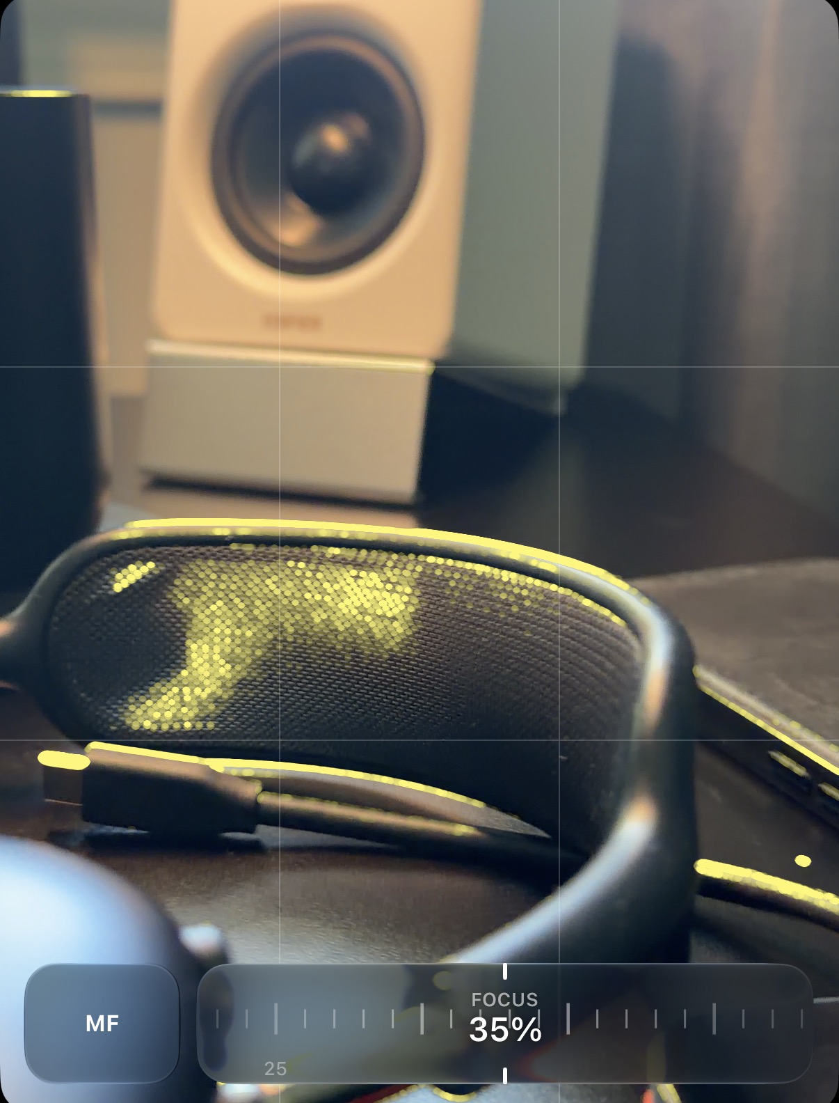 Yellow focus peaking tracing the edges of headphones, with the complete manual-focus control set to 35 percent